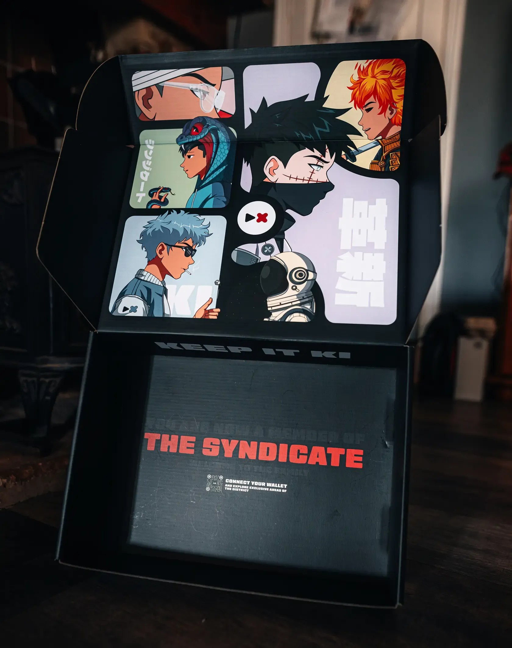 A photo of the Adaki box, open, showing the box artwork
