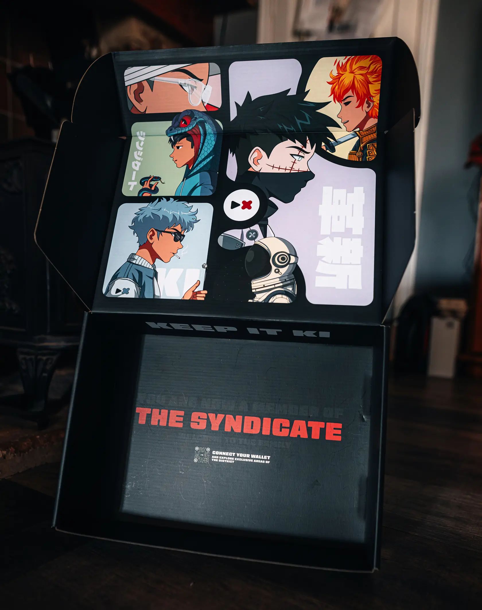 A photo of the Adaki box, open, showing the box artwork